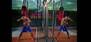 Thai boxer's reflection in a mirror