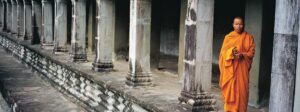 Monk in an orange-colored robe at Angkor Wat, Cambodia