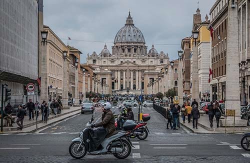Motorcycles and pedestrians in Rome