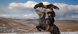 Mongolian eagle hunter on horseback
