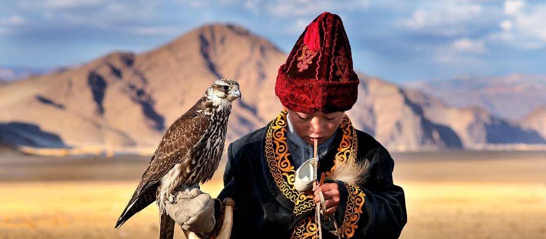 Young Falcon and a young eagle hunter in Mongolia
