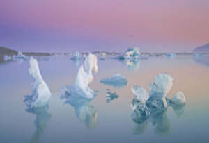 Evening and long exposure shooting of the transparent icebergs floating in the glacier lagoon Jökulsárlón