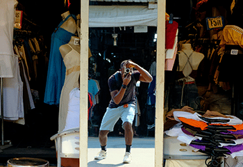 a man photographing the Chatuchak market with dressed dummies in background